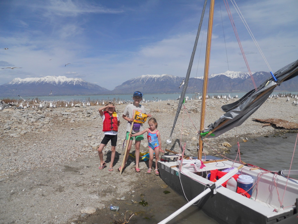 Abby, Eliza, and Stella plant the "Earl" flag on Bird Island.